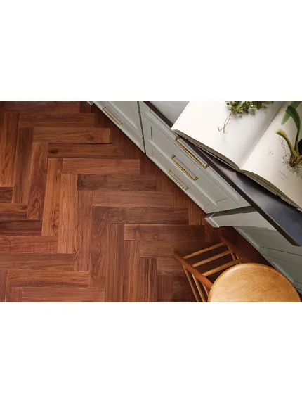 Top down view of a herringbone hardwood floor in a kitchen